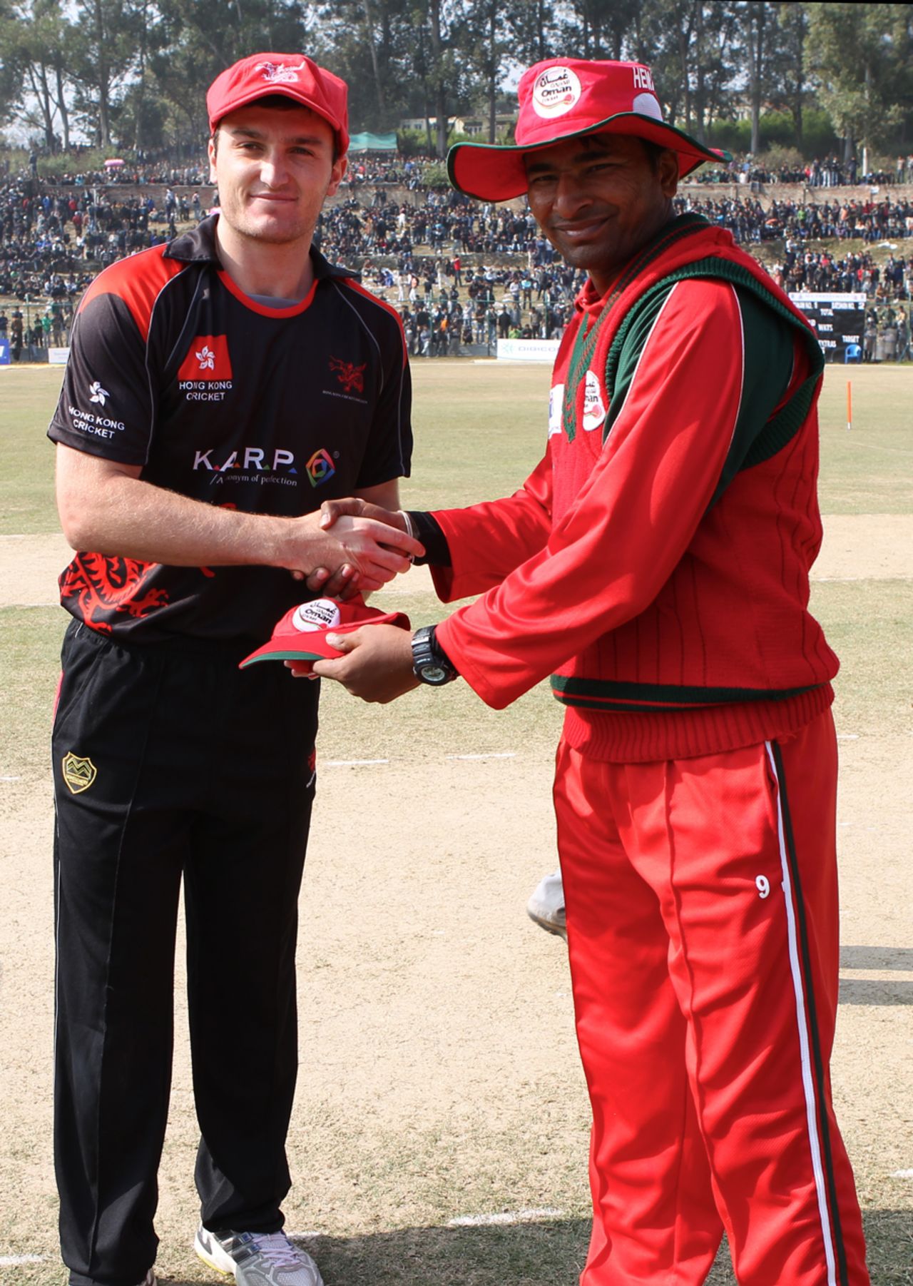 Jamie Atkinson shakes hands with Oman skipper Hemal Mehta during the coin toss for the ACC Twenty20 Cup 2011 semi-final played in Kathmandu on 9th December 2011