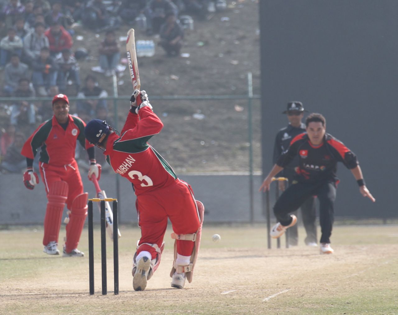 Oman's Vaibhav Wategaonkar hits Roy Lamsam down the ground for a single during the ACC Twenty20 Cup 2011 semi-final in Kathmandu on 9th December 2011