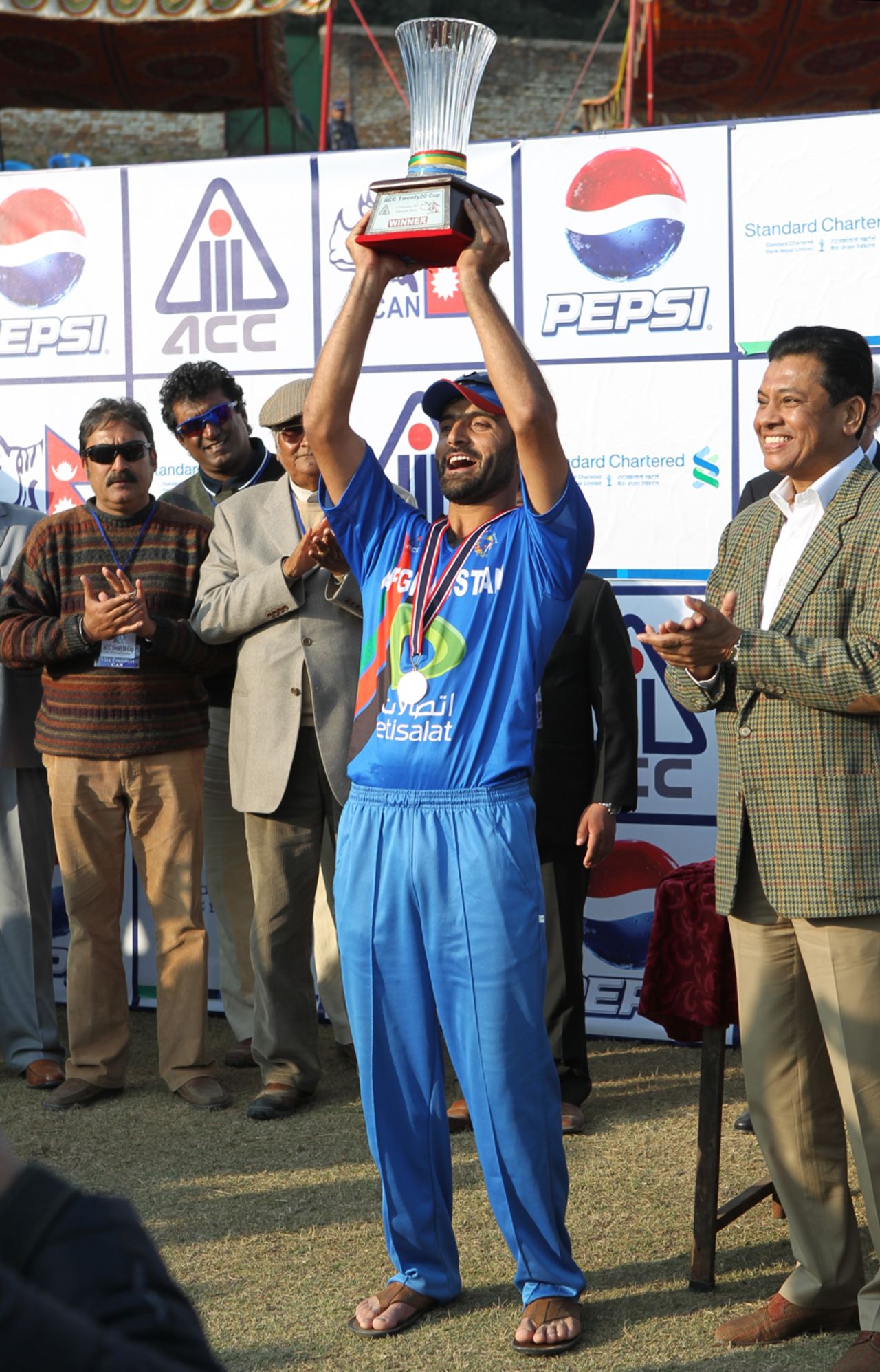 Afghanistan's skipper Nawroz Mangal lifts the ACC Twenty20 Cup 2011 Winners' Trophy after his team beat Hong Kong by 8 runs in the final played in kathmandu on 11th December 2011