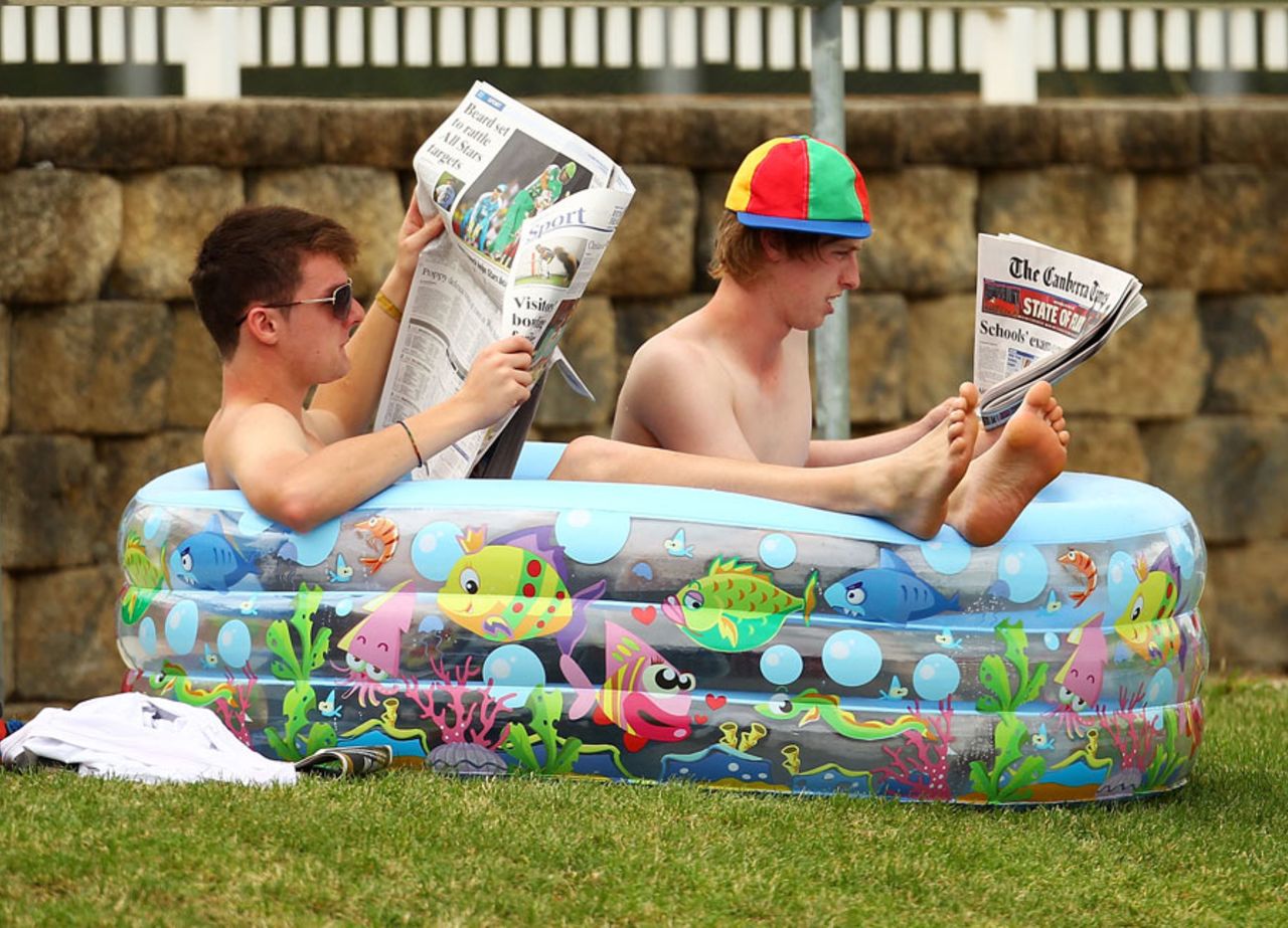 Fans relax in a blow-up swimming pool, Cricket Australia Chairman's XI v Indians, Canberra, 3rd day, December 21, 2011