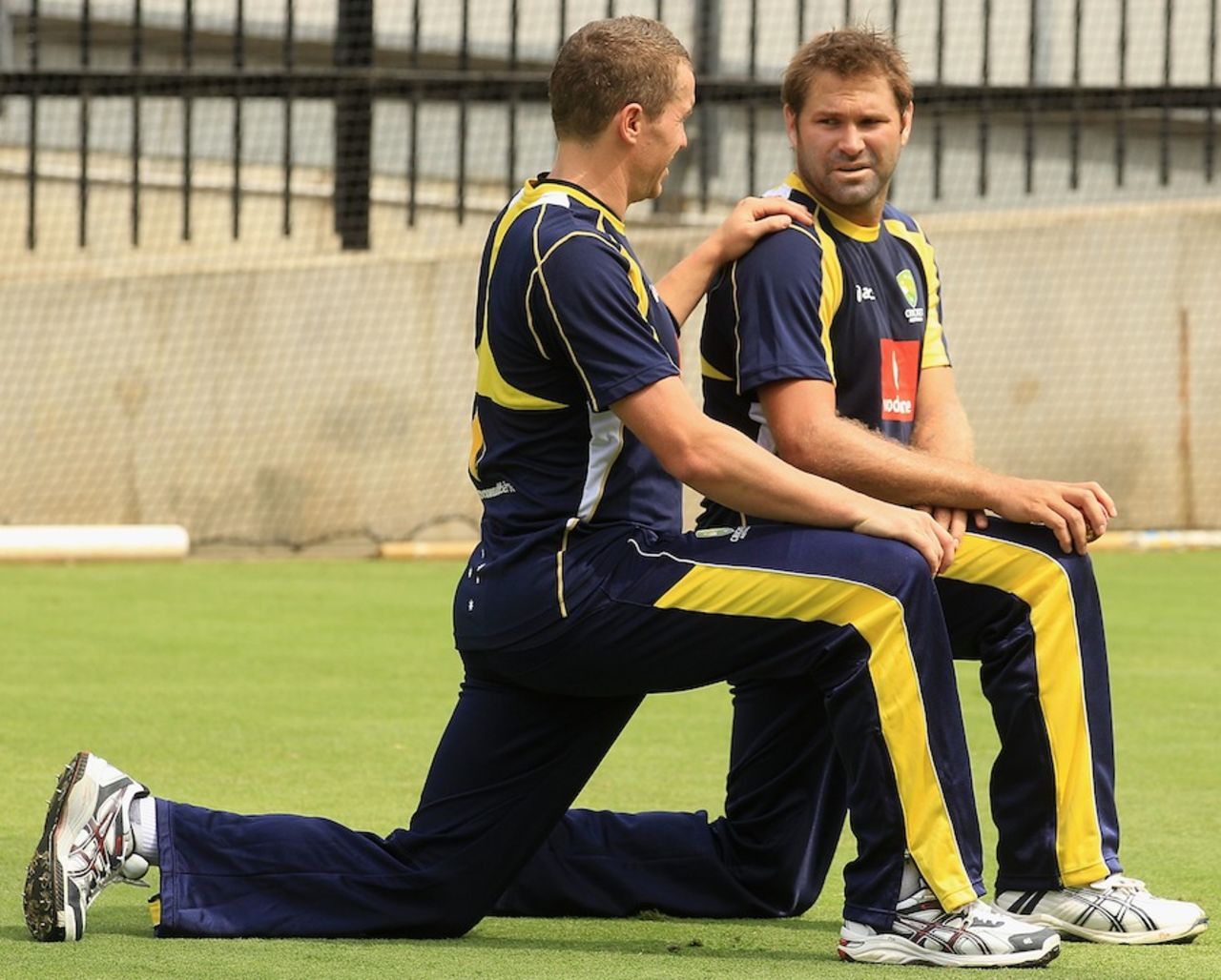Peter Siddle and Ryan Harris stretch, Melbourne, December 23, 2011