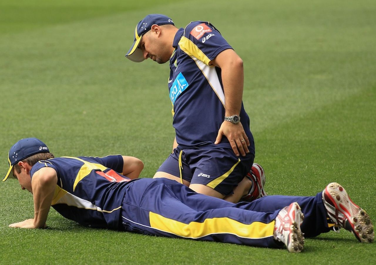 Australia's physio Alex Kountouris checks on Shaun Marsh, Melbourne, December 24, 2011