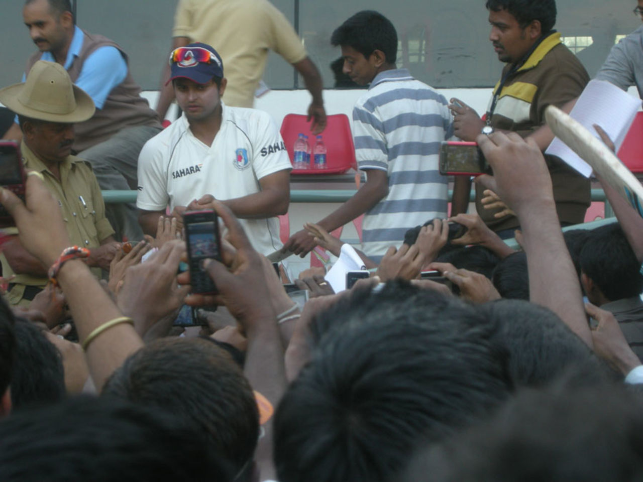 Suresh Raina is mobbed by autograph hunters after stumps, Karnataka v Uttar Pradesh, Ranji Trophy Elite, Shimoga, 3rd day, December 23, 2011