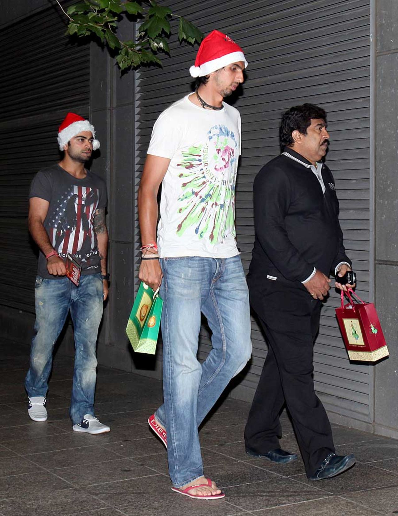 Virat Kohli and Ishant Sharma take a walk with their Santa hats on, Melbourne, December 24, 2011