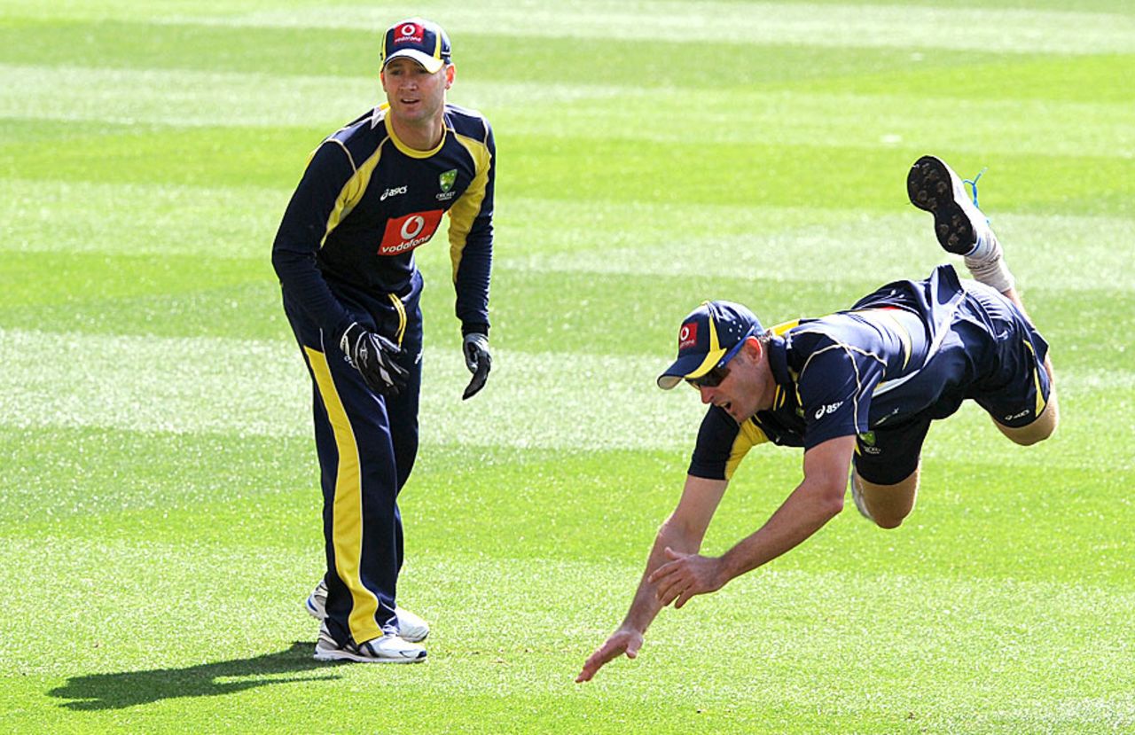 Michael Hussey dives to field as Michael Clarke looks on, Melbourne, December 25, 2011