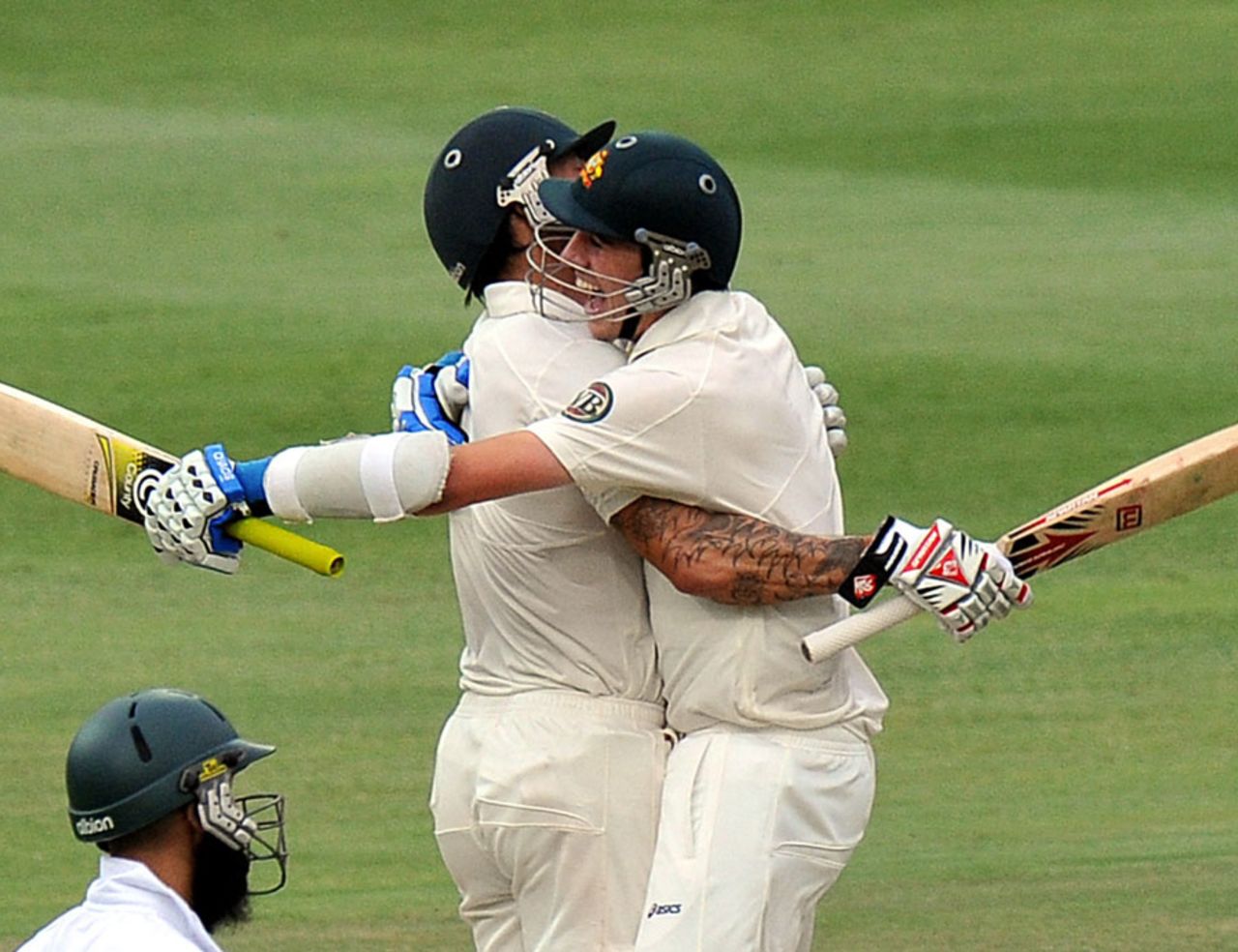 Pat Cummins and Mitchell Johnson celebrate the culmination of a thrilling chase, South Africa v Australia, 2nd Test, Johannesburg, 5th day, November 21, 2011
