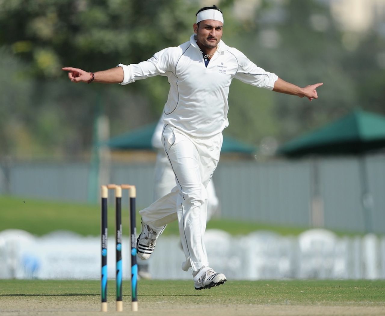 Hamid Hassan celebrates the dismissal of Andrew Strauss, ICC Combined XI v England XI, Dubai, 2nd day, January 8, 2012