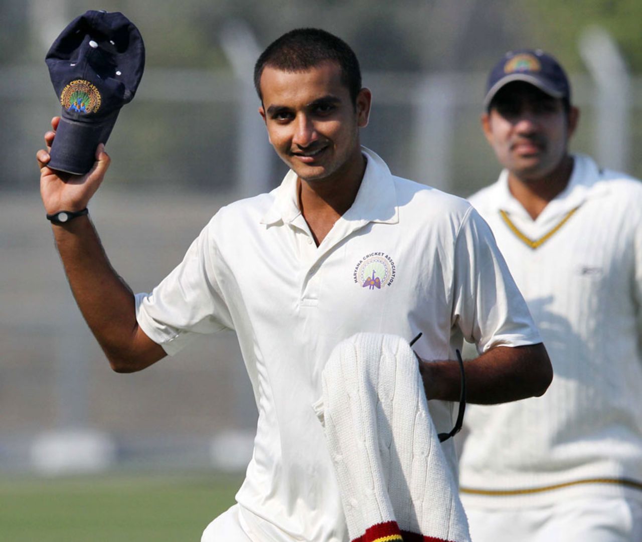 Harshal Patel raises his cap after his eight-wicket haul, Haryana v Rajasthan, 1st semi-final, Ranji Trophy 2011-12, Rohtak, 1st day, January 10, 2012 
