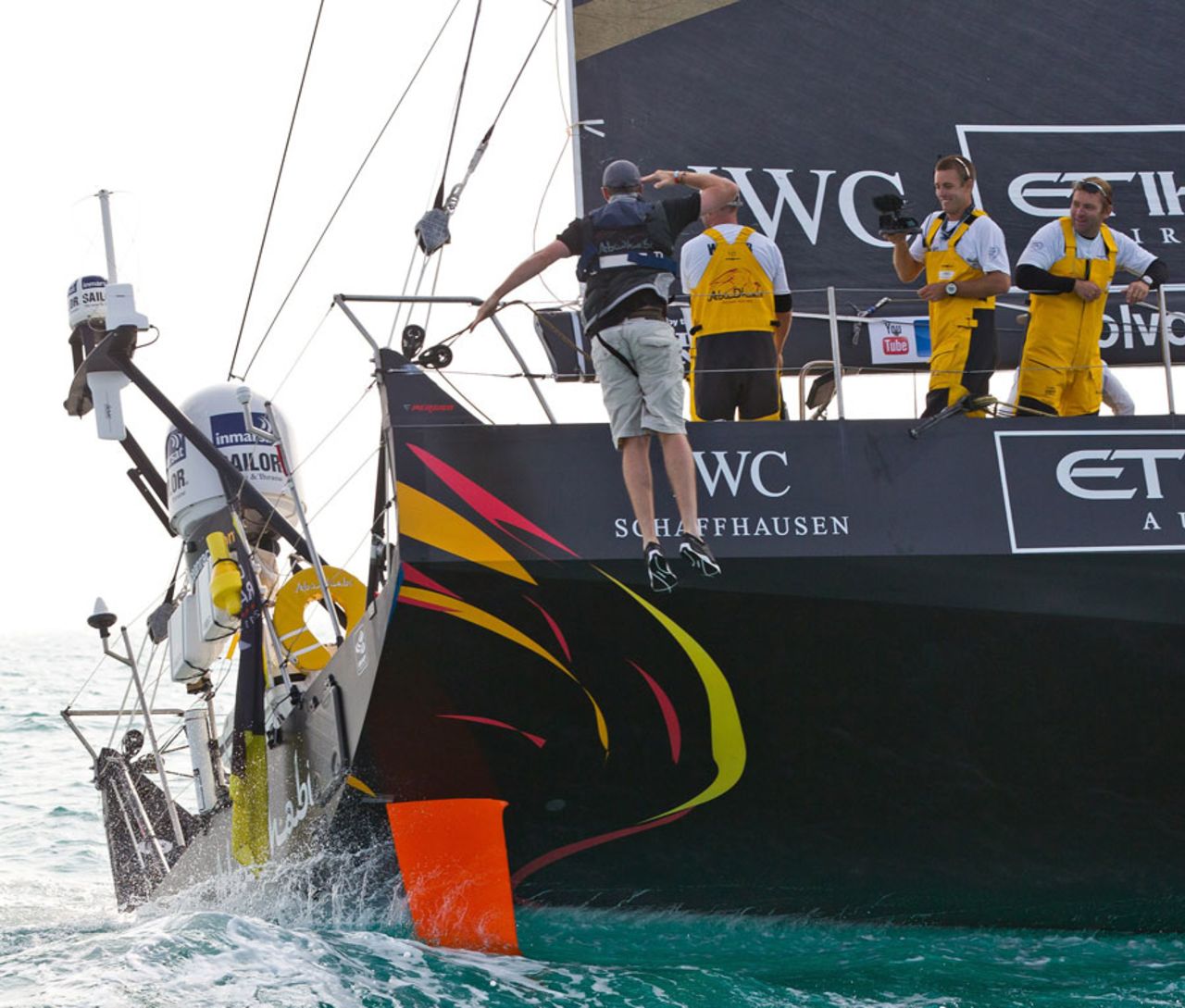 Graeme Swann jumps from the yacht of Abu Dhabi Ocean Racing after joining the crew for part of the round the world race, Abu Dhabi, January 14, 2012