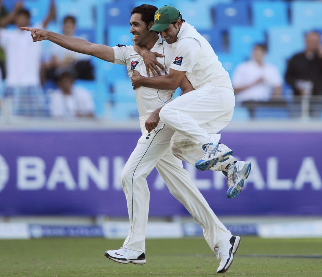 Umar Gul and Abdur Rehman celebrate Jonathan Trott's dismissal, Pakistan v England, 1st Test, Dubai, 3rd day, January 19, 2012