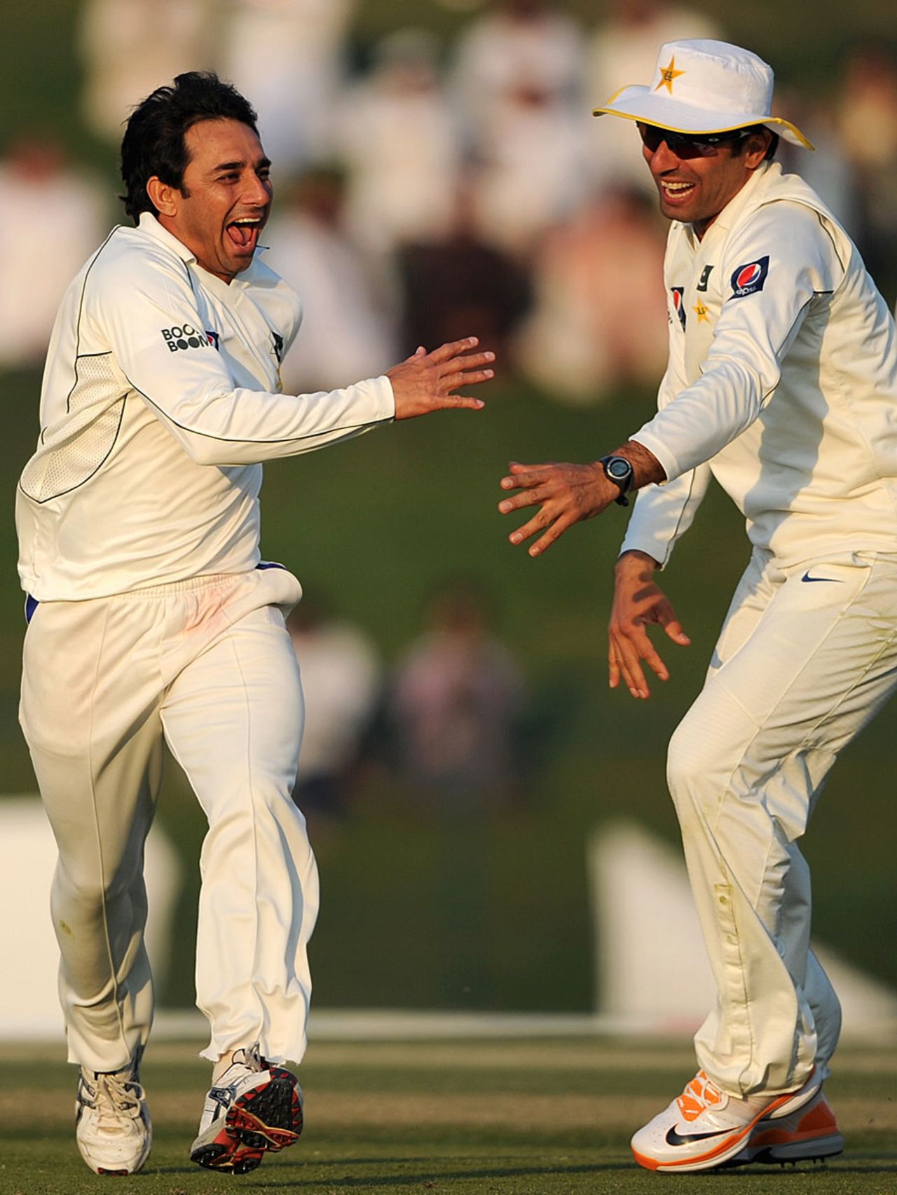 An ecstatic Saeed Ajmal celebrates a strike with Misbah-ul-Haq, Pakistan v England, 2nd Test, Abu Dhabi, 2nd day, January 26, 2012