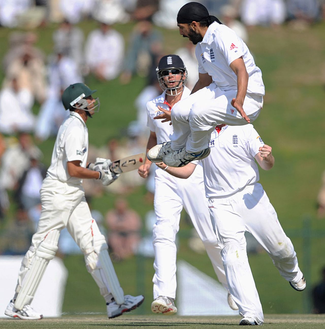 Monty Panesar leaps after bowling Younis Khan, Pakistan v England, 2nd Test, Abu Dhabi, 3rd Day, January 27, 2012