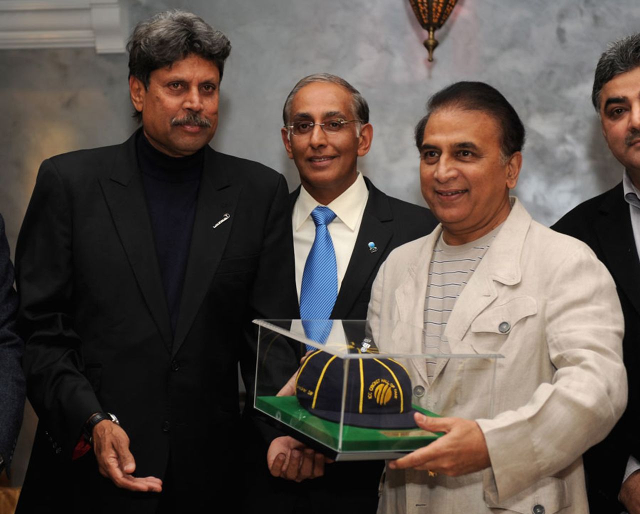 Sunil Gavaskar gets his ICC Hall of Fame cap from Kapil Dev, Dubai, February 8, 2012