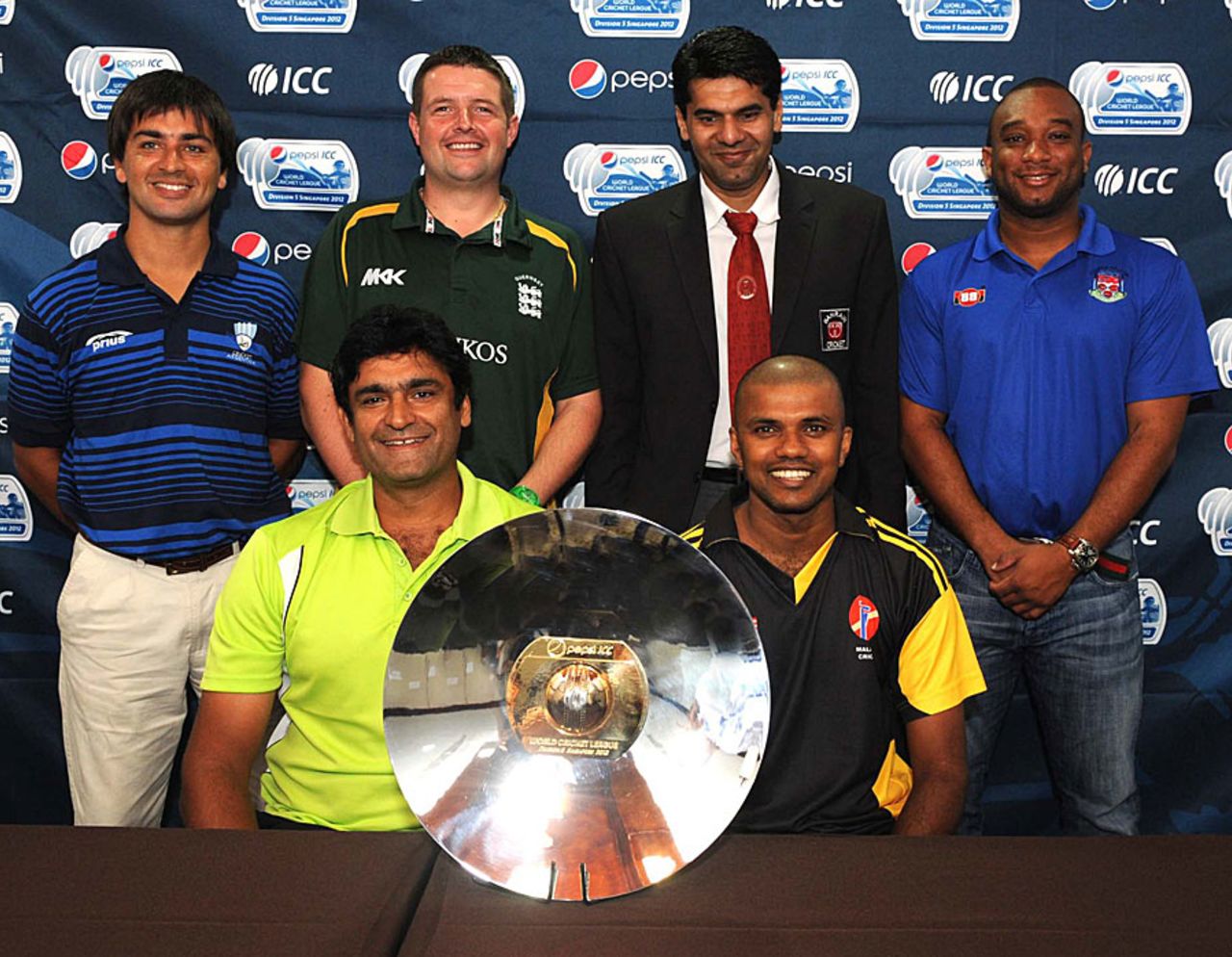 Captains pose with the ICC World Cricket League Division 5 trophy, Singapore, February 17, 2012