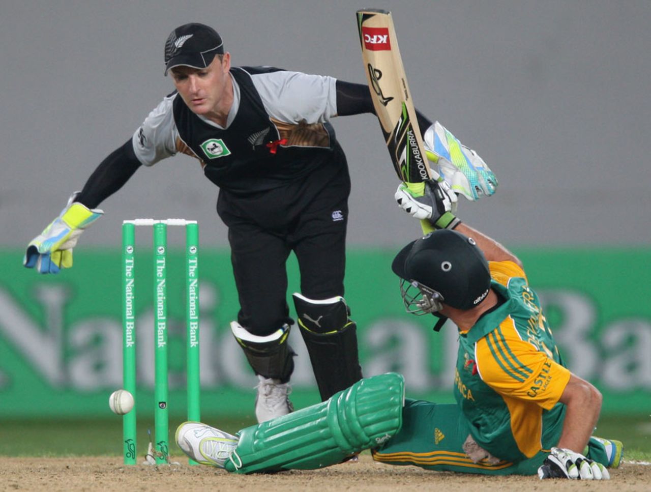 Brendon McCullum reaches for the ball after AB de Villiers falls over attempting a stroke, New Zealand v South Africa, 3rd Twenty20, Auckland, February 22, 2012