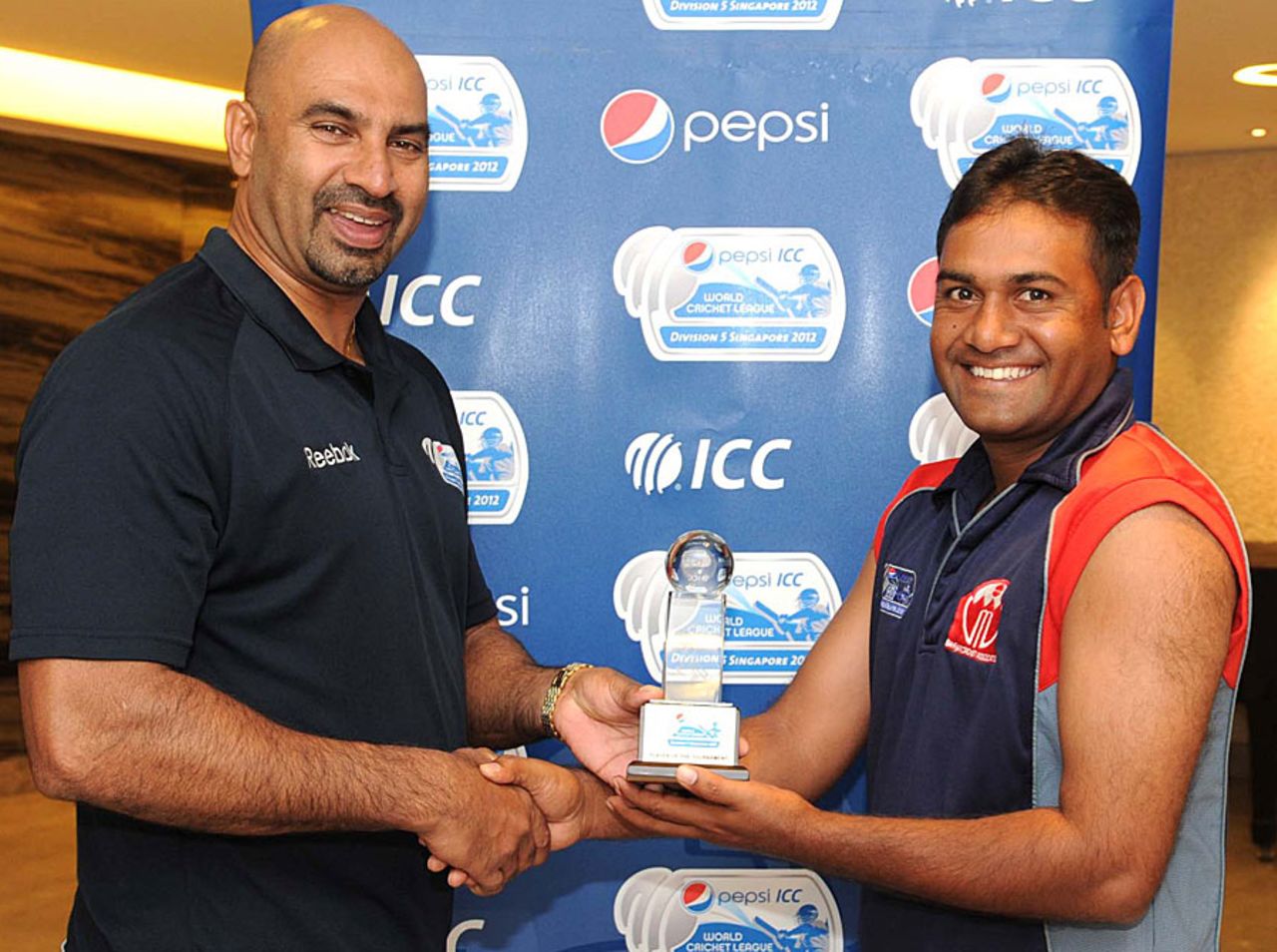 Bahrain's Adil Hanif receives the Player of the tournament award from Graeme Labrooy, Argentina v Bahrain, ICC World Cricket League Division Five, Fifth place play-off, Singapore, February 25, 2012