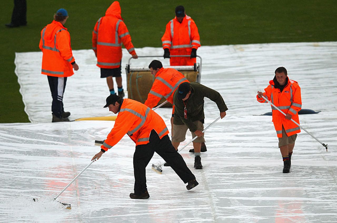 The groundstaff try to mop the water off the covers, New Zealand v South Africa, 1st Test, Dunedin, 5th day, March 11, 2012