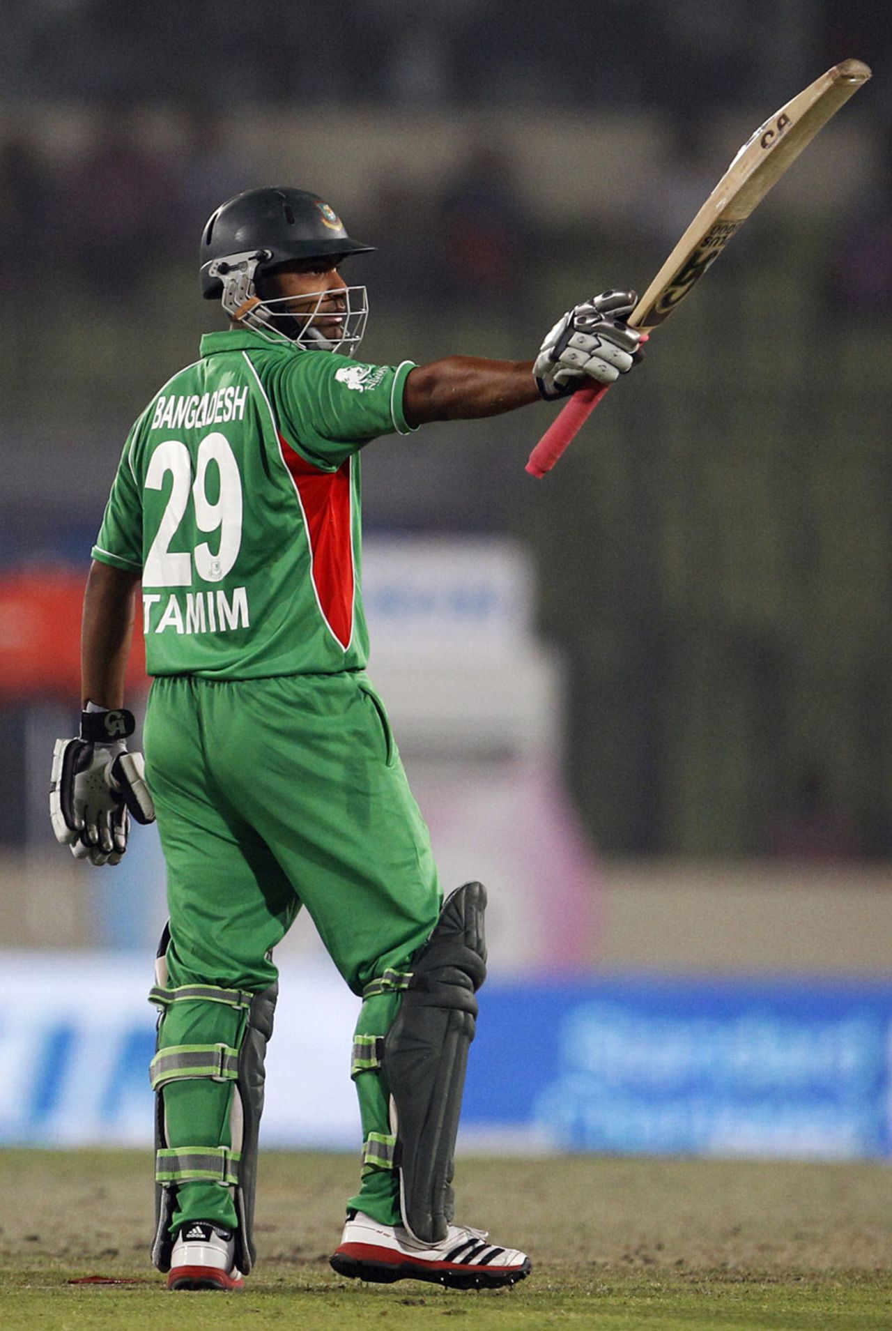 Tamim Iqbal raises his bat after reaching a half-century, Bangladesh v Pakistan, Asia Cup, Mirpur, March 11, 2012
