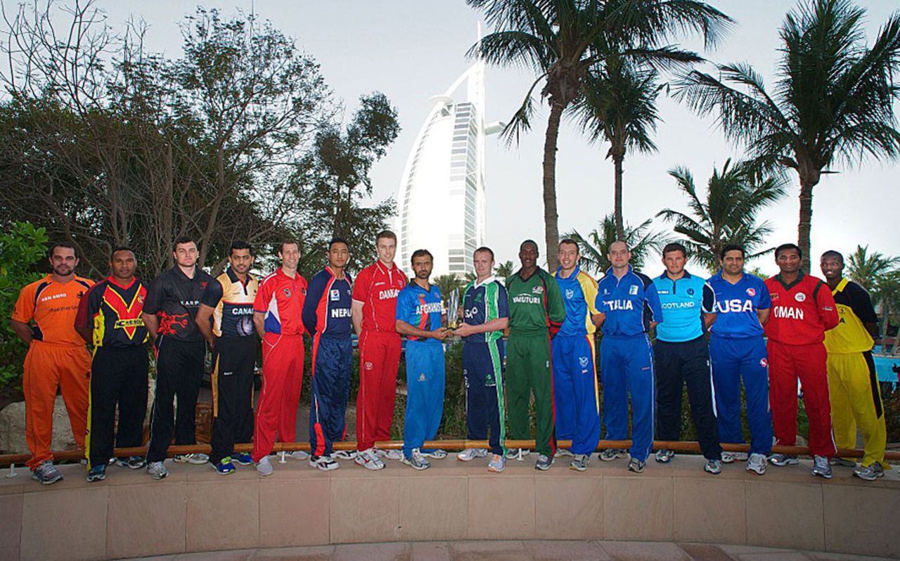 The captains of the 16 teams of the ICC World Twenty20 Qualifier 2012 pose with the trophy, Dubai, March 12, 2012