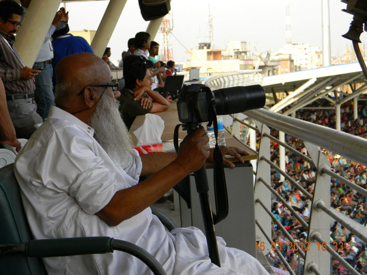 Veteran Bangladeshi photographer Al Haj Mahammad Zahirul Haq watches Sachin Tendulkar reach his 100th ton, Bangladesh v India, Asia Cup, Mirpur, March 16, 2012