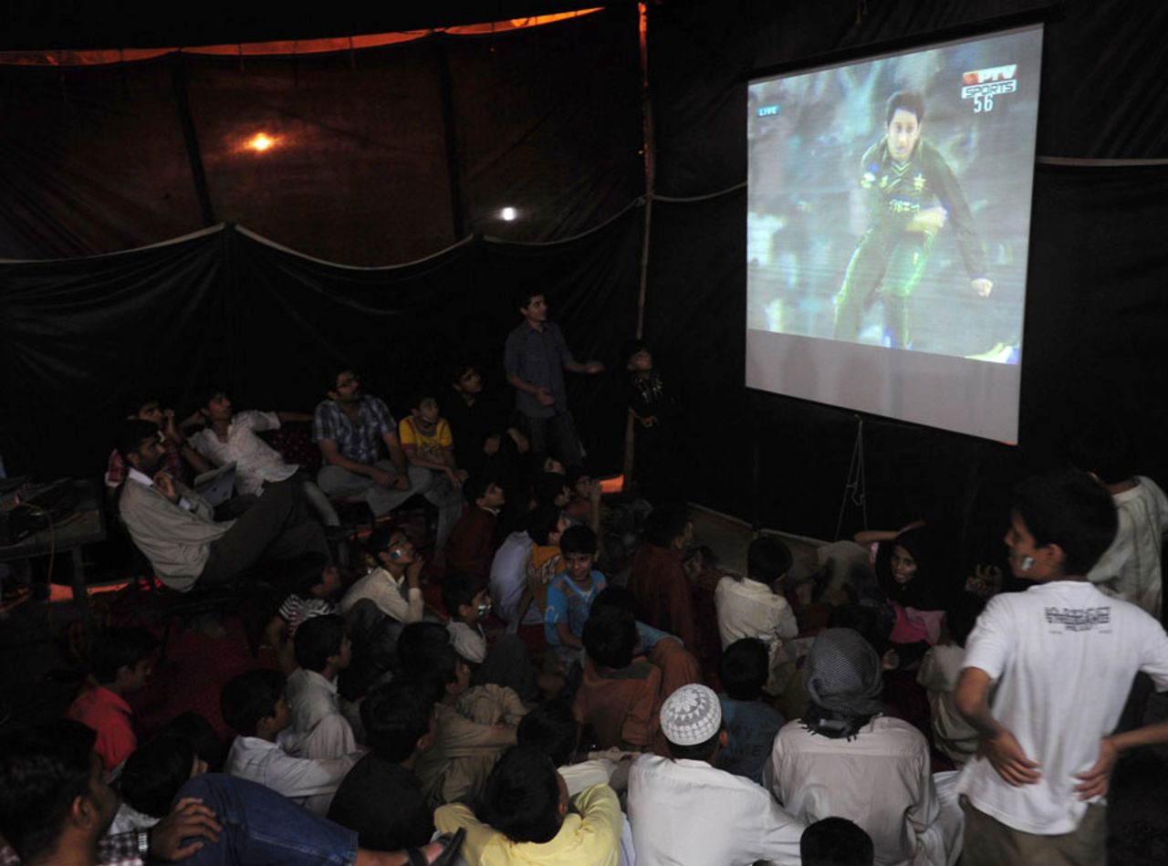 Pakistani fans watch their team play India in the Asia Cup, Karachi, March 18, 2012