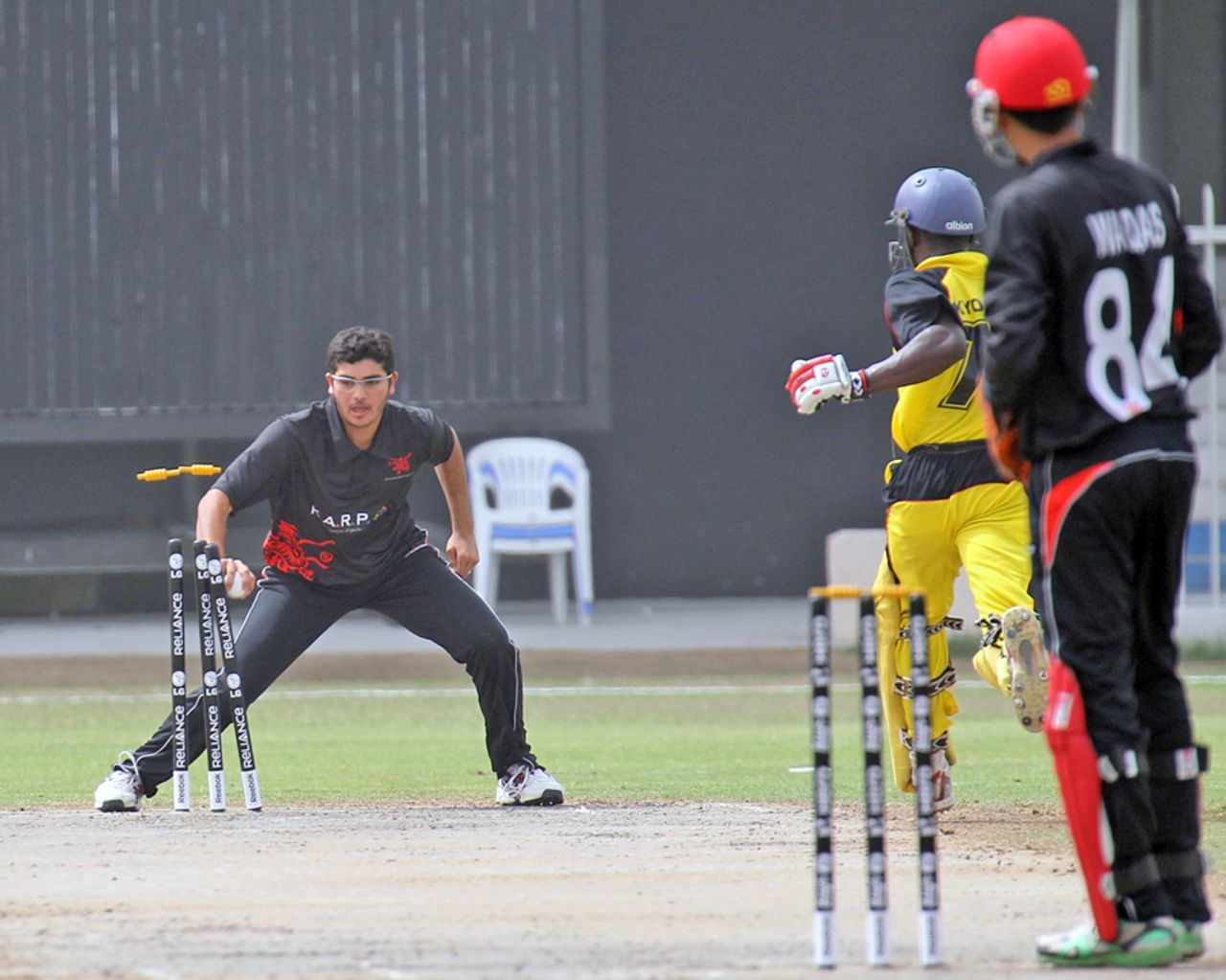 A smart piece of fielding by Kinchit Shah affects the run-out of Uganda's Arthur Kyobe during the 11th Place Play-off match at the ICC World Twenty20 Qualifier played at Sharjah Cricket Stadium on 22nd March 2012