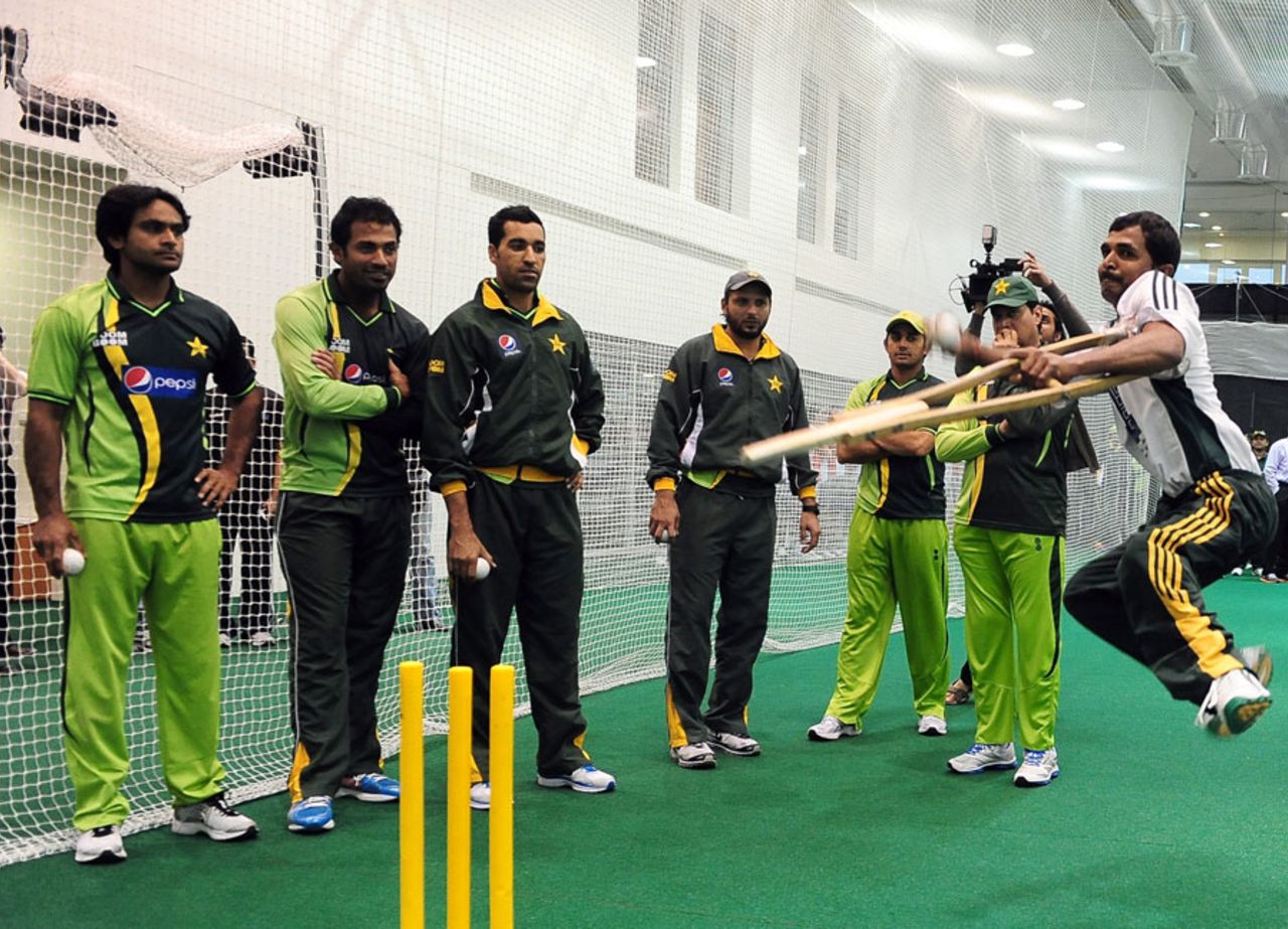 Pakistan players watch Farhan Saeed bowl in the nets, Dubai, February 17, 2012
