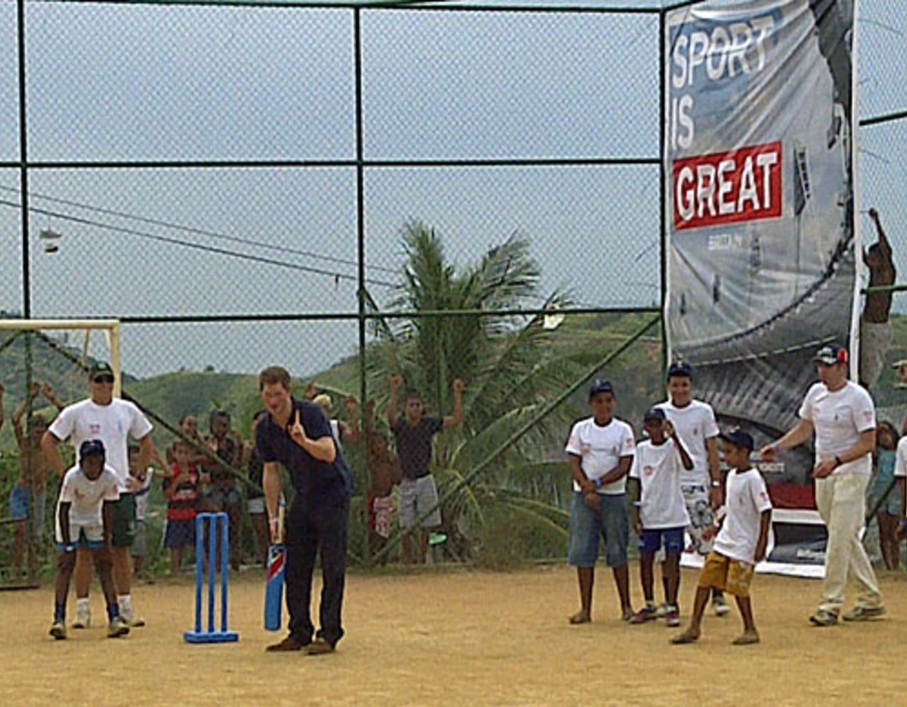 Prince Harry plays taco, a Brazilian version of cricket, with local kids