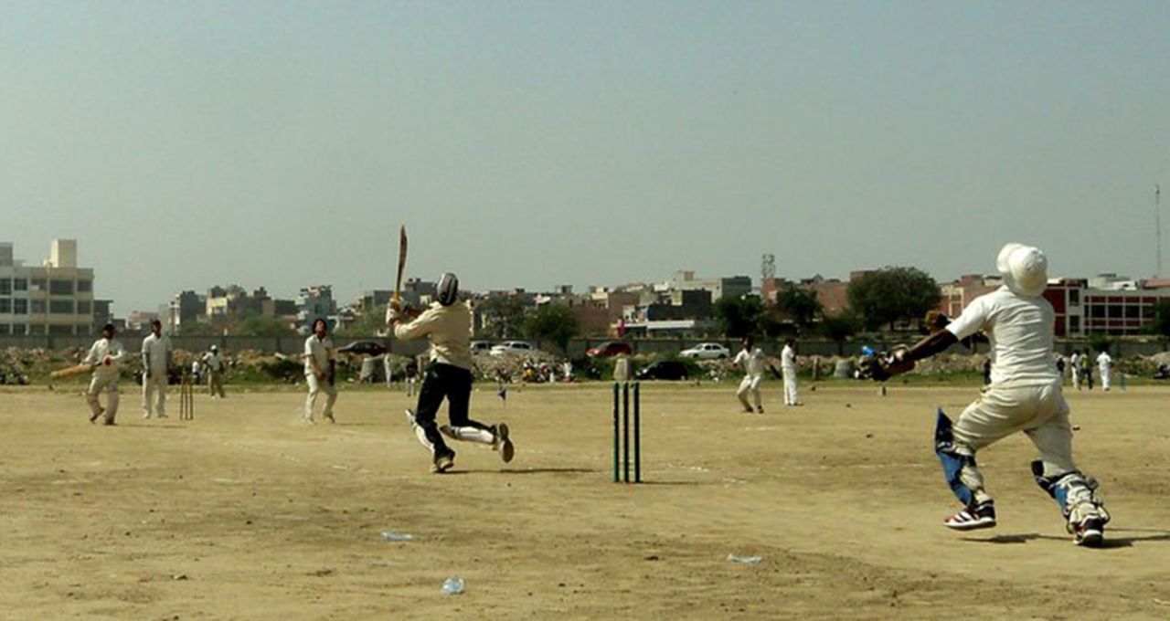The ball goes high in the air as the batsman mishits the ball in a local match at the Mukherjee Nagar ground in New Delhi. . Submitted by: <b>Omesh Meena</b>