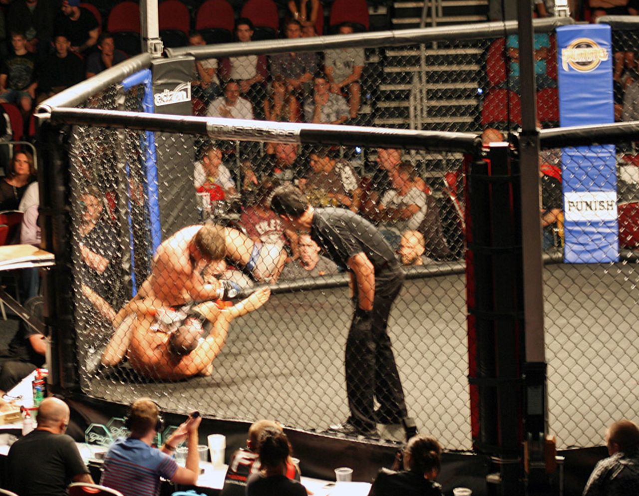 Adam Hollioake (bottom) in a mixed martial arts cage fight, Gold Coast, May 5, 2012