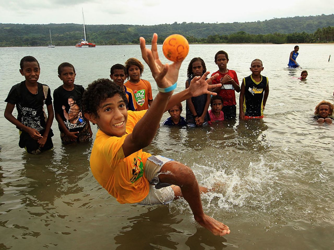 Children play catch in the water during an ICC development event in Vanuatu, May 16, 2012
