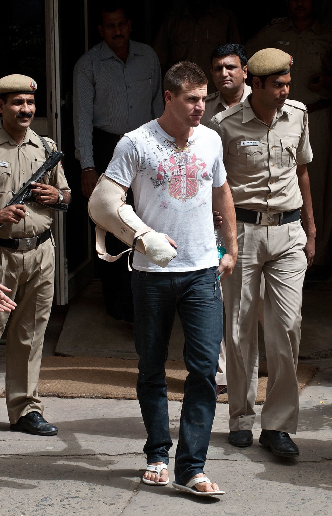 Luke Pomersbach is escorted to a court hearing by police, Delhi, May 18, 2012