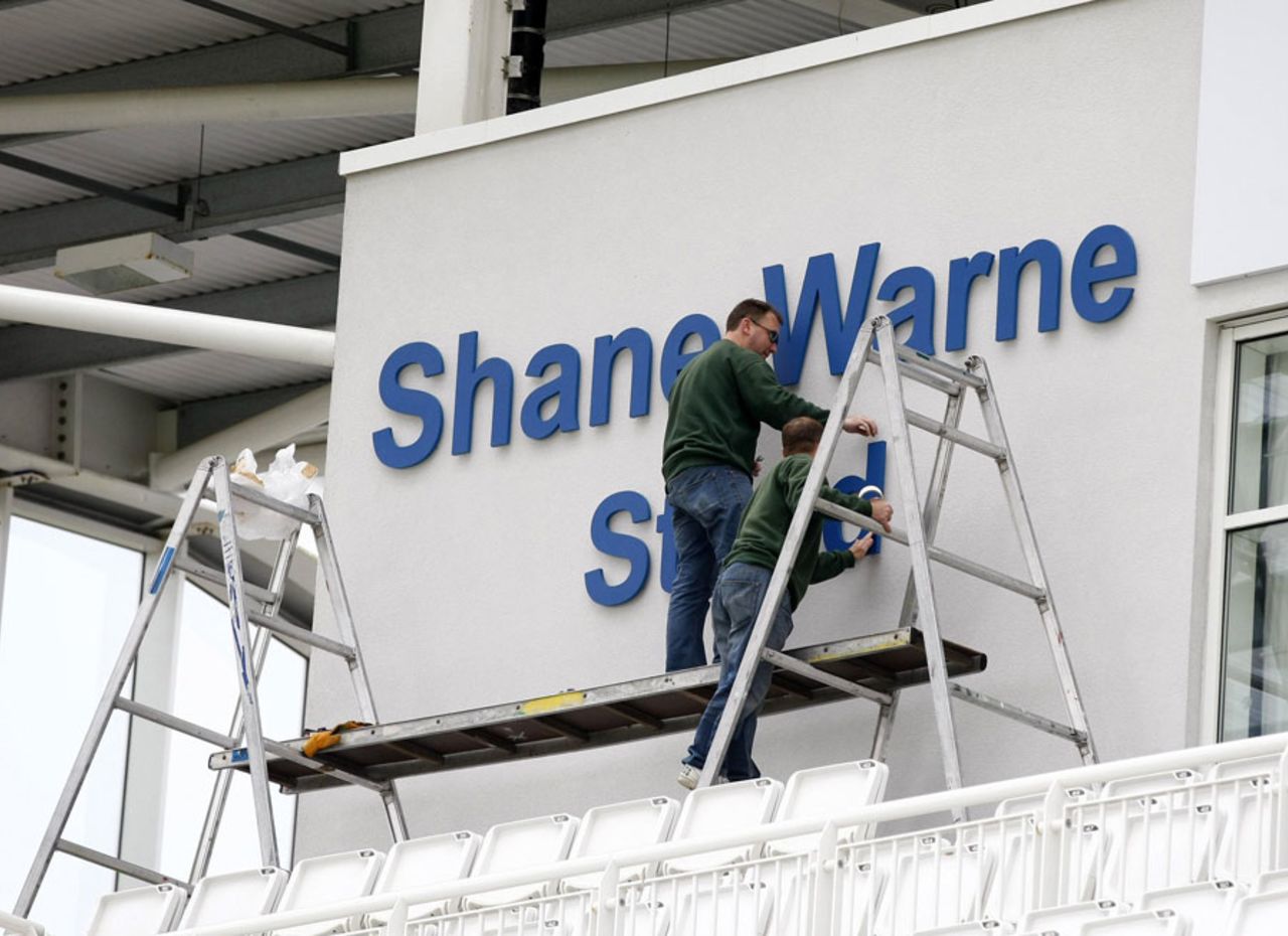 Workmen finish the re-branding of one of the main stands, West End, June, 15, 2012
