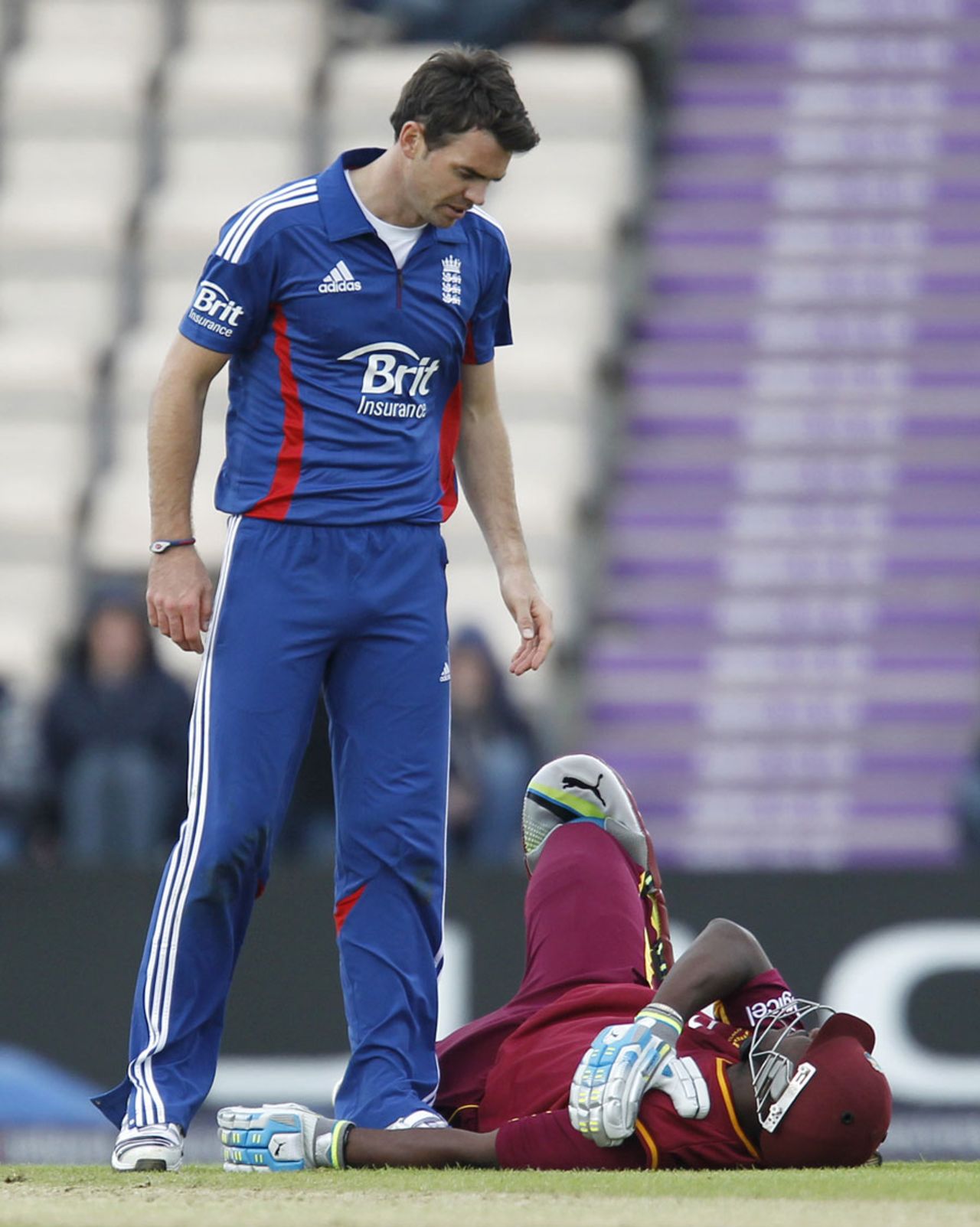 James Anderson inspects Andre Russell who collapsed with a shoulder injury, England v West Indies, 1st ODI, West End, June 16, 2012
