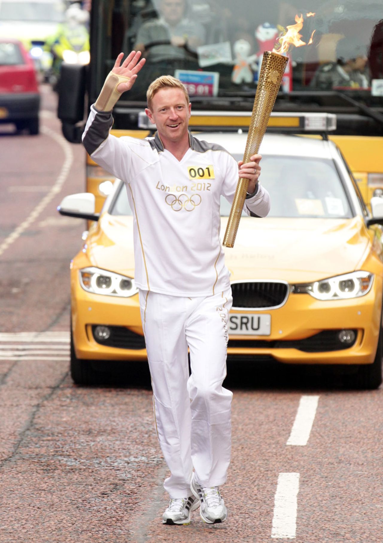 Paul Collingwood carries the Olympic torch on the latest leg of its relay around Britain, Durham, June 17, 2012