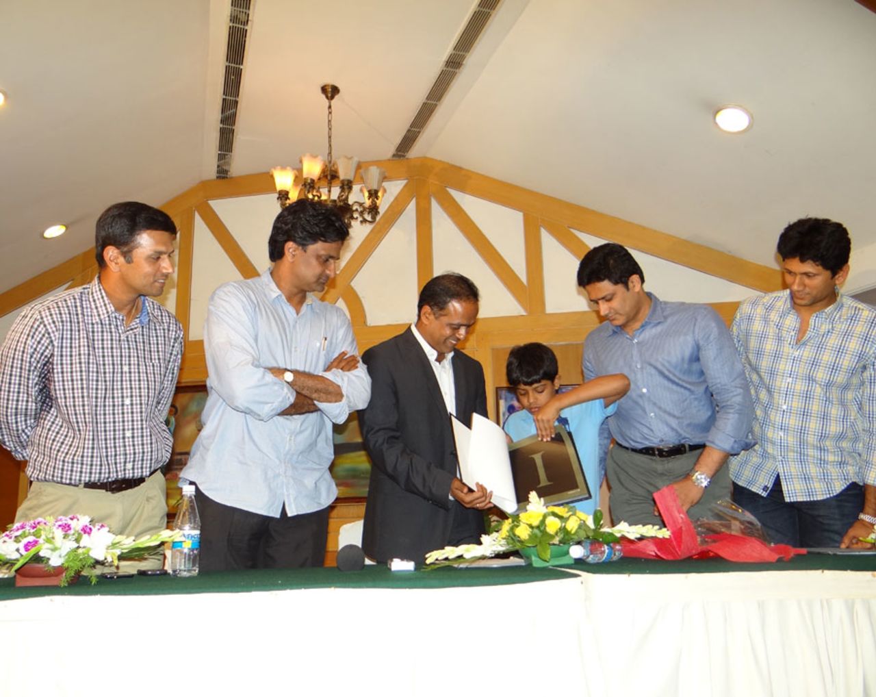 Rahul Dravid, Javagal Srinath, Anil Kumble and Venkatesh Prasad watch as  Sunil Joshi is presented a book by his son, Bangalore, June 21, 2012