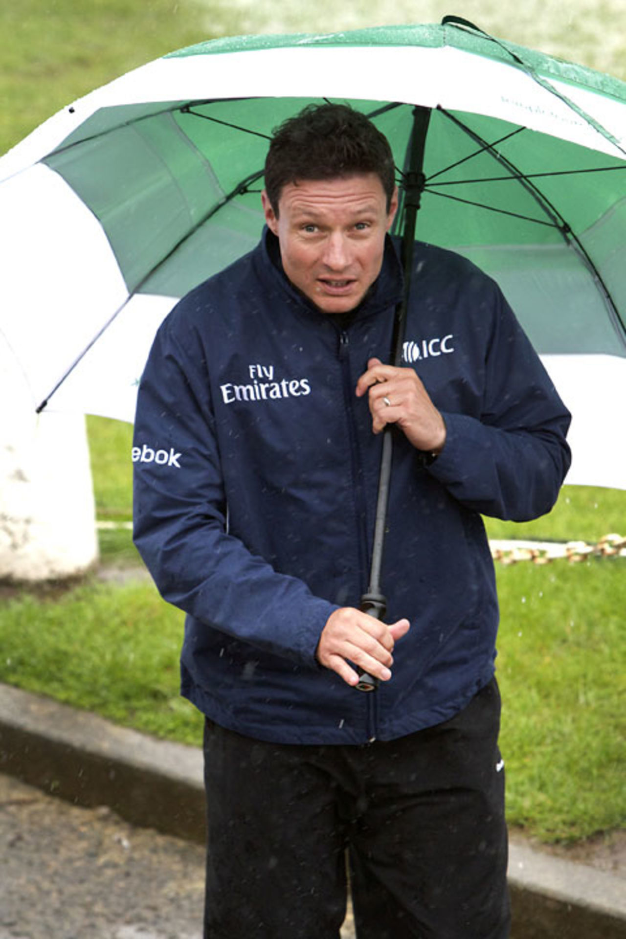 Richard Kettleborough shelters from the rain in Belfast, June 22, 2012