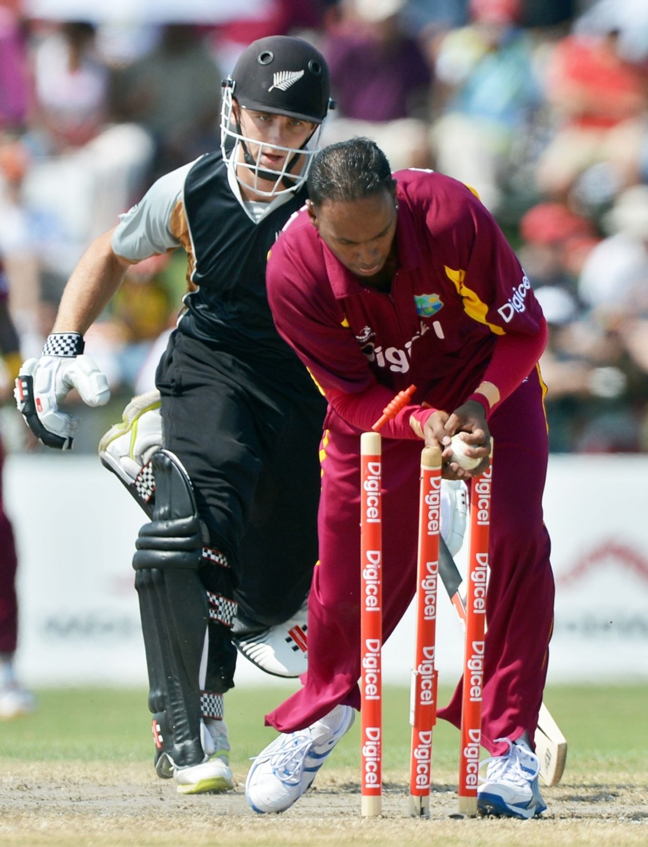 Samuel Badree breaks the stumps to run out Kane Williamson, West Indies v New Zealand, 2nd Twenty20, Florida, July 1, 2012