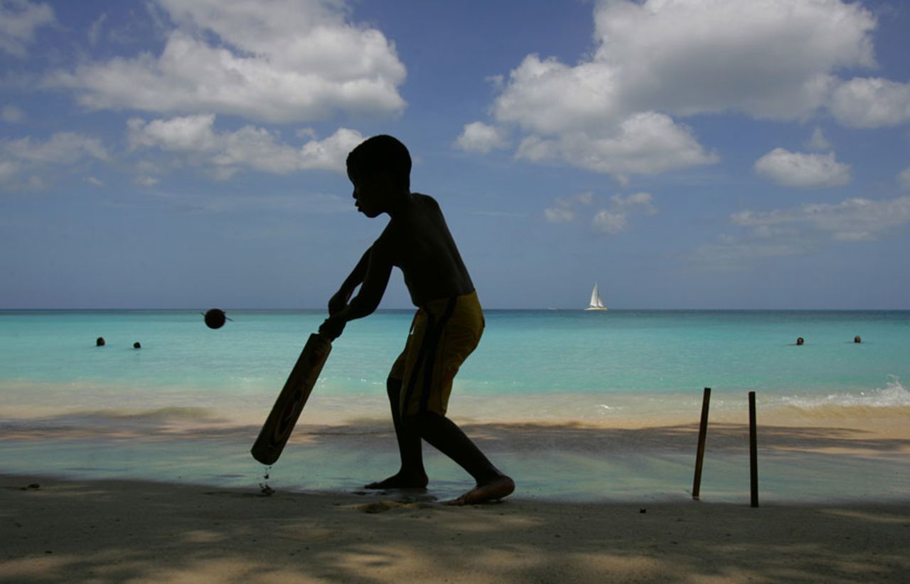 A boy playing cricket on a beach in Barbados, 2007