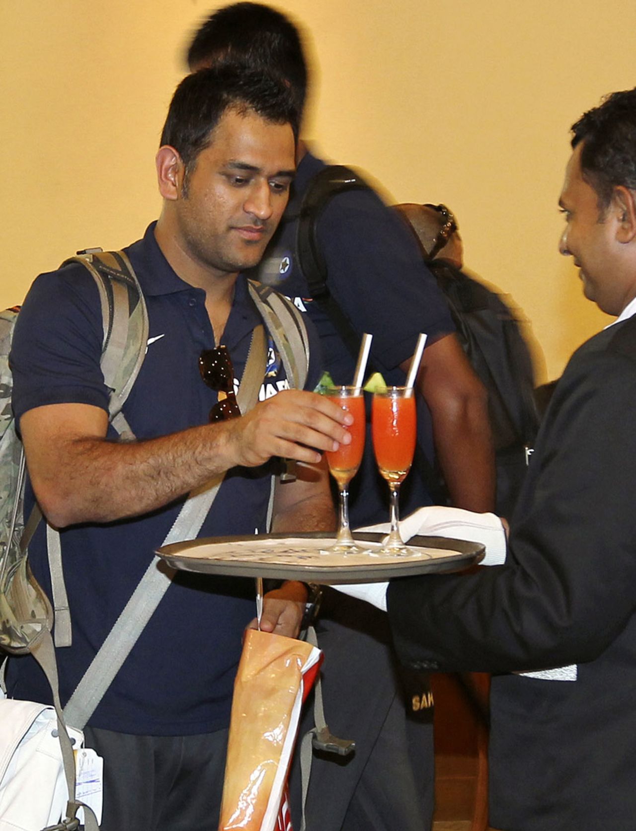 MS Dhoni accepts a welcome drink at a Colombo hotel, July 18, 2012