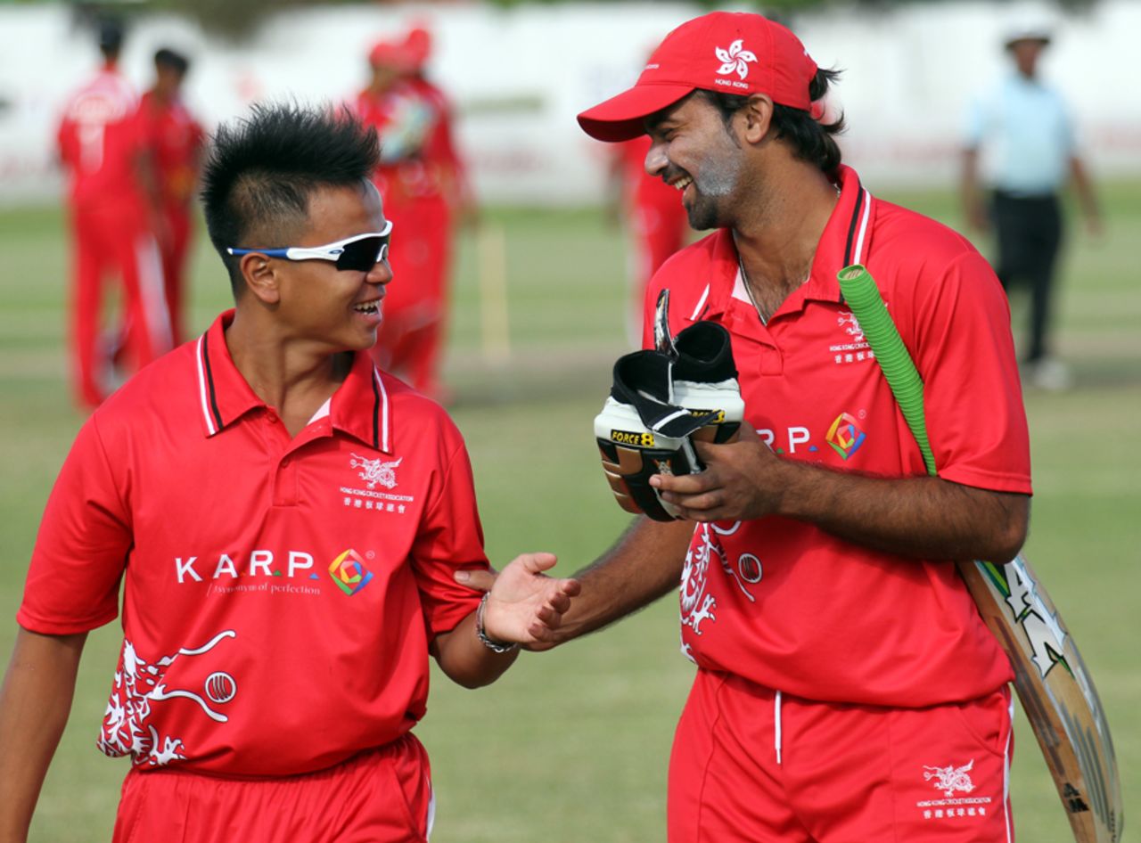 Li Kai Ming and Haseeb Amjad share a lighter moment after Hong Kong's record T20 score against Singapore