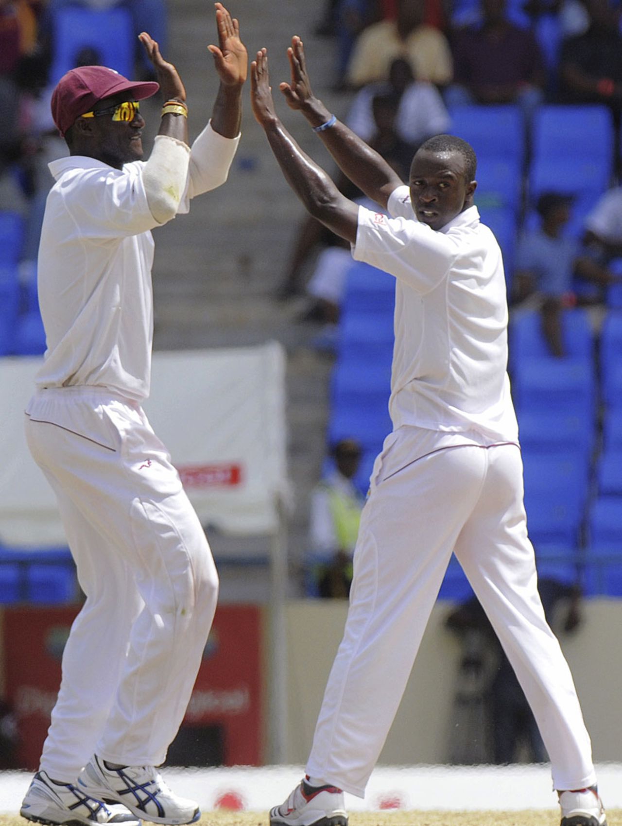Kemar Roach celebrates one of his five wickets with Darren Sammy, West Indies v New Zealand, 1st Test, Antigua, 5th day, July 29, 2012