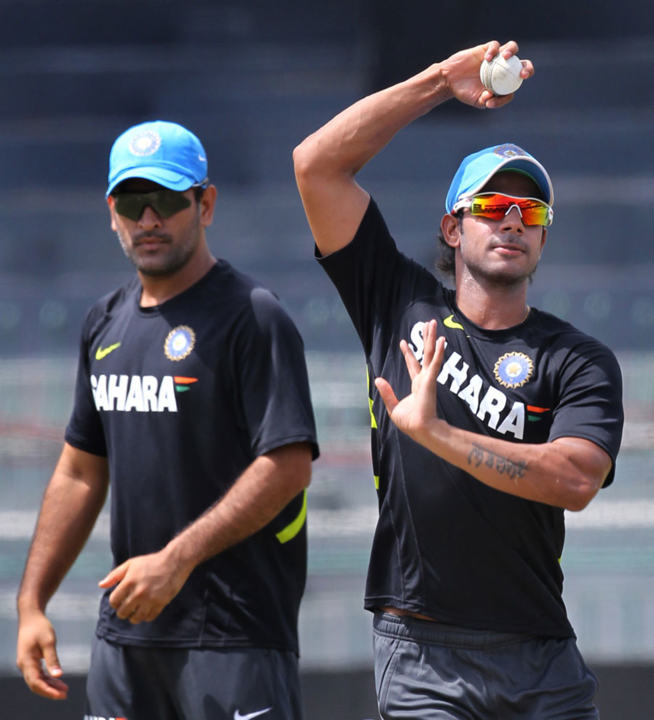 MS Dhoni watches Manoj Tiwary  bowl at a training session, Colombo, July 30, 2012