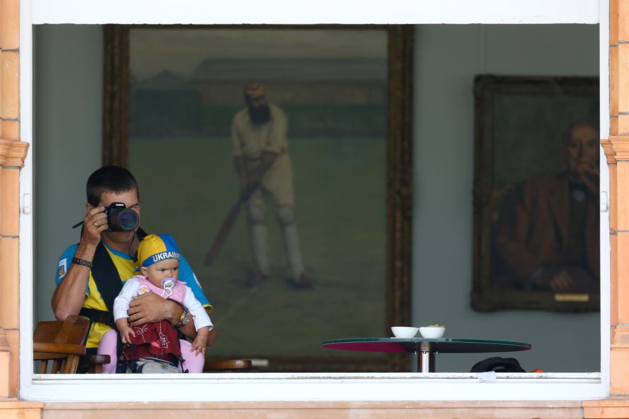 A Ukraine supporter takes a picture of the archery from inside the Long Room, Lord's, July 30, 2012
