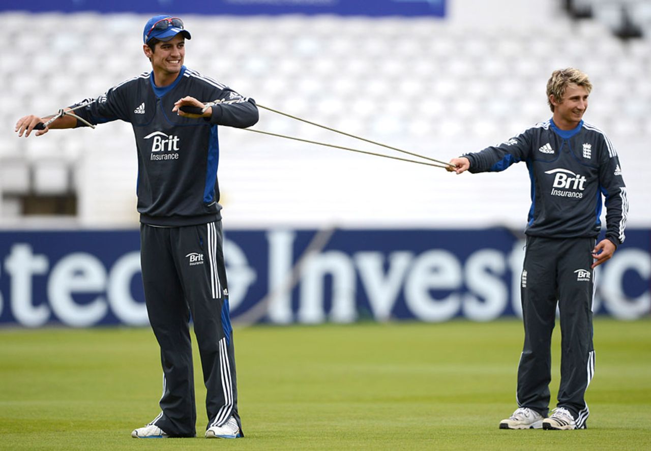 James Taylor helps out Alastair Cook during training, Headingley, July 31, 2012