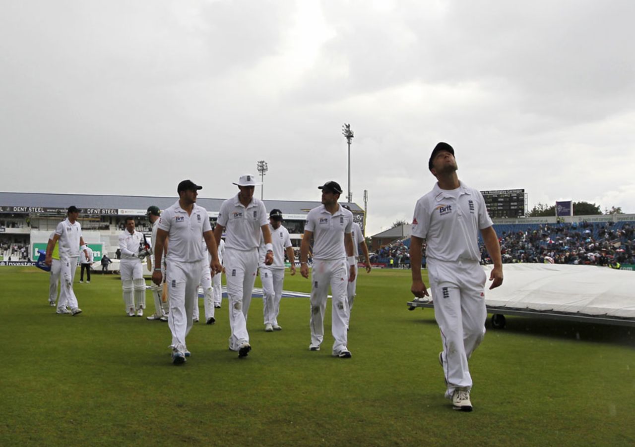 Players leave the field as the covers come on for a second time, England v South Africa, 2nd Investec Test, Headingley, 4th day, August 5, 2012