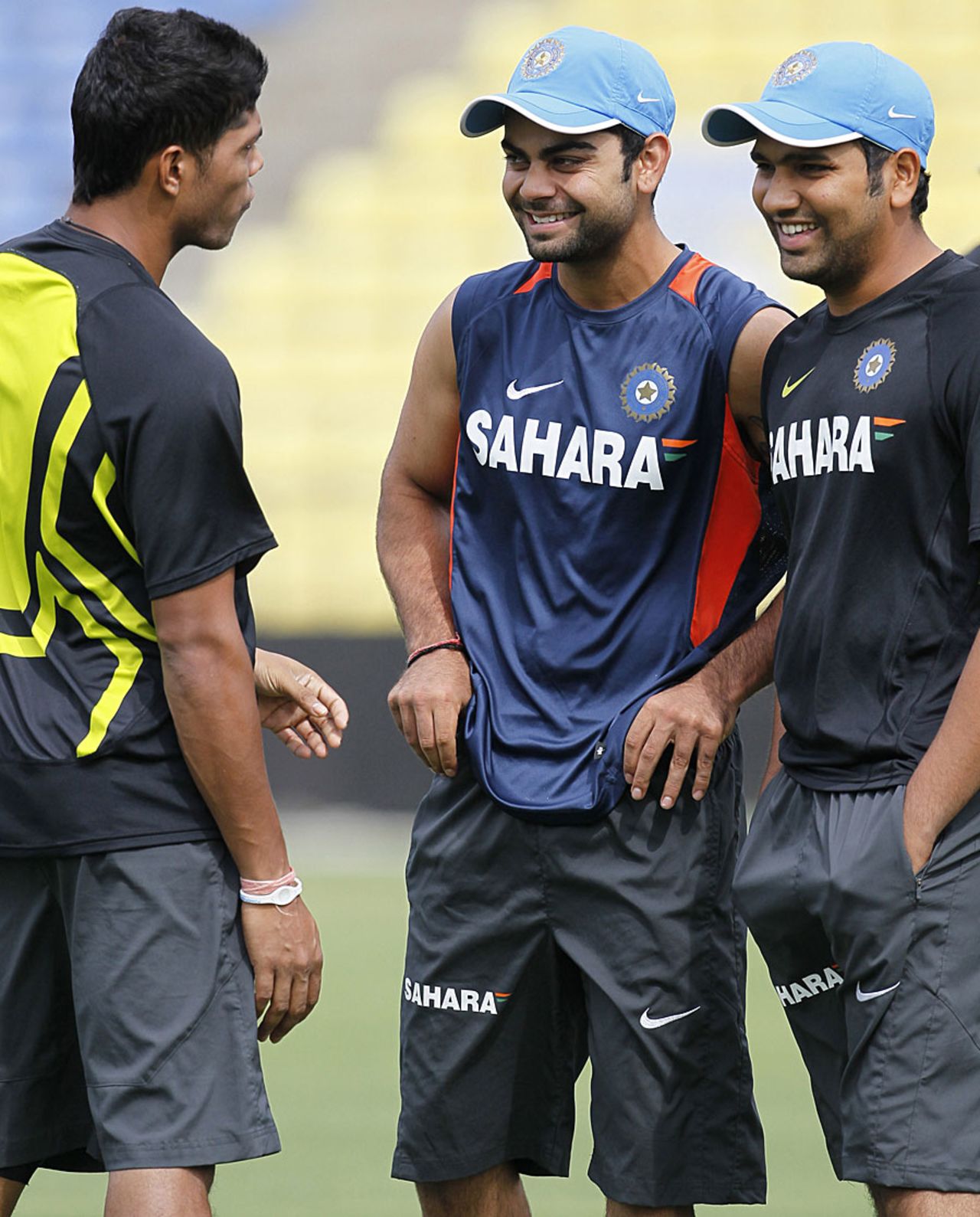 Umesh Yadav, Virat Kohli and Rohit Sharma take a break during training, Pallekele, August 6, 2012