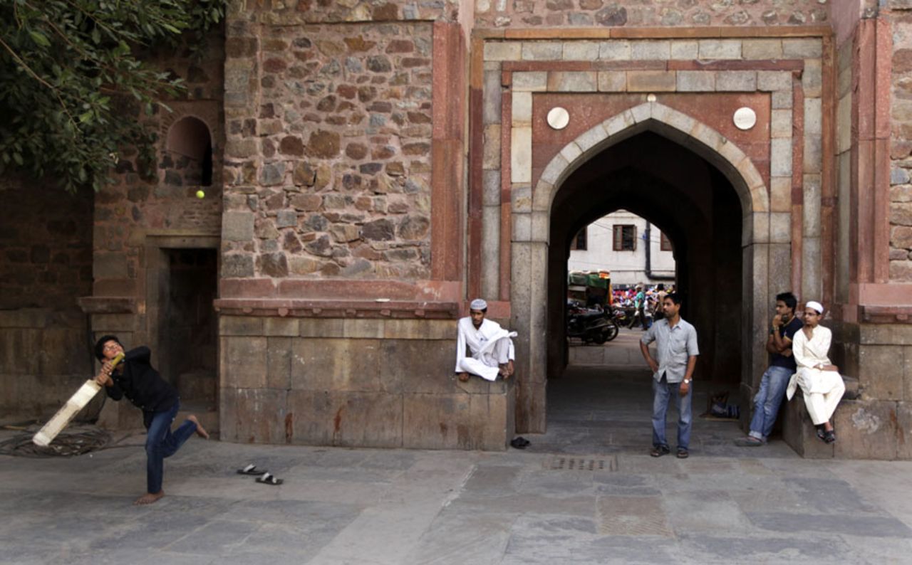 Boys plays cricket near the Sufi saint Nizamuddin Auliya dargaha, or shrine, in New Delhi