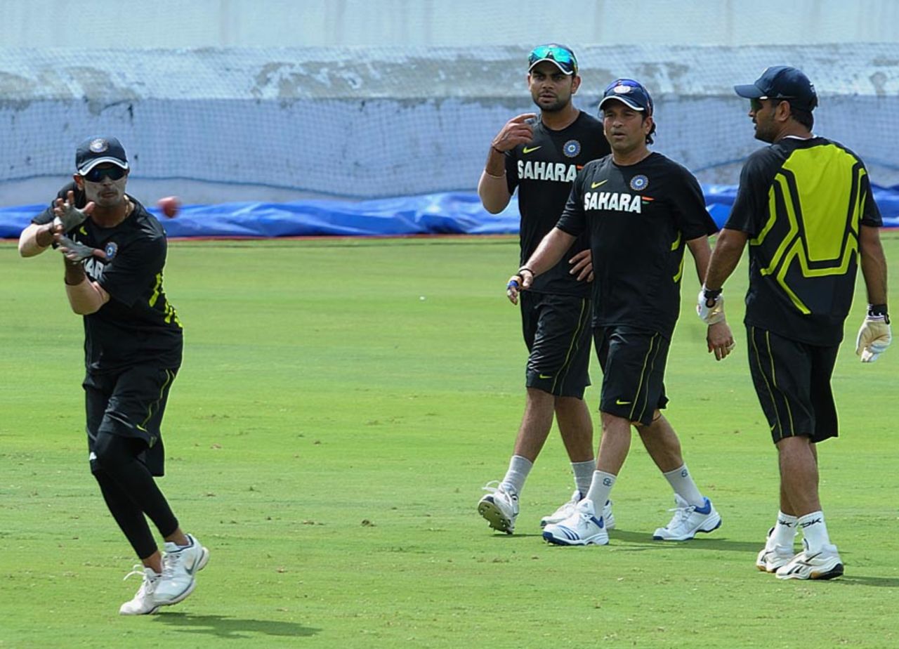 Subramaniam Badrinath practices catching as his team-mates look on, Hyderabad, August 20, 2012