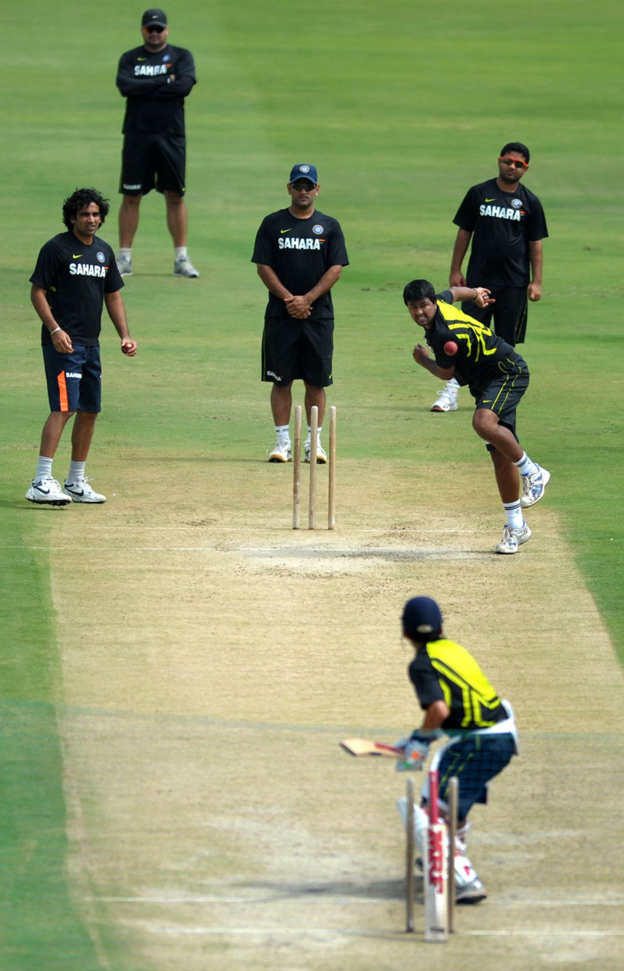 Pragyan Ojha has a bowl, watched by his team-mates, Hyderabad, August 22, 2012